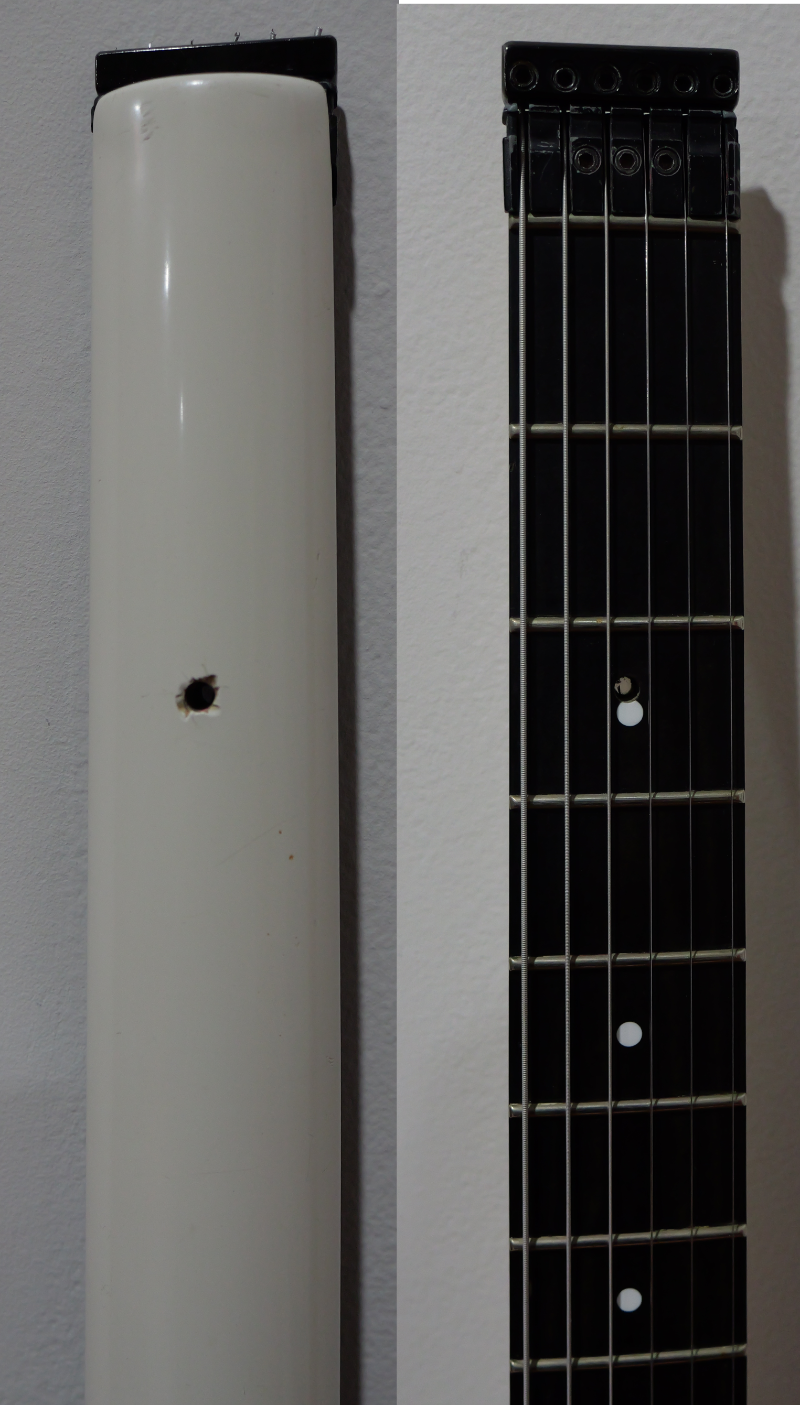 Hole drilled in neck near 3rd fret dot.